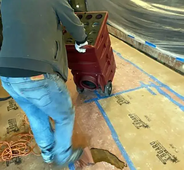 Worker moving equipment on a construction site