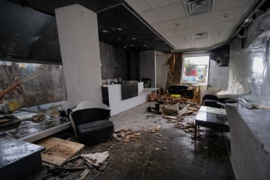 Interior of a damaged commercial space after disaster.