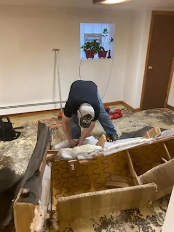 Person repairing furniture in a renovated room